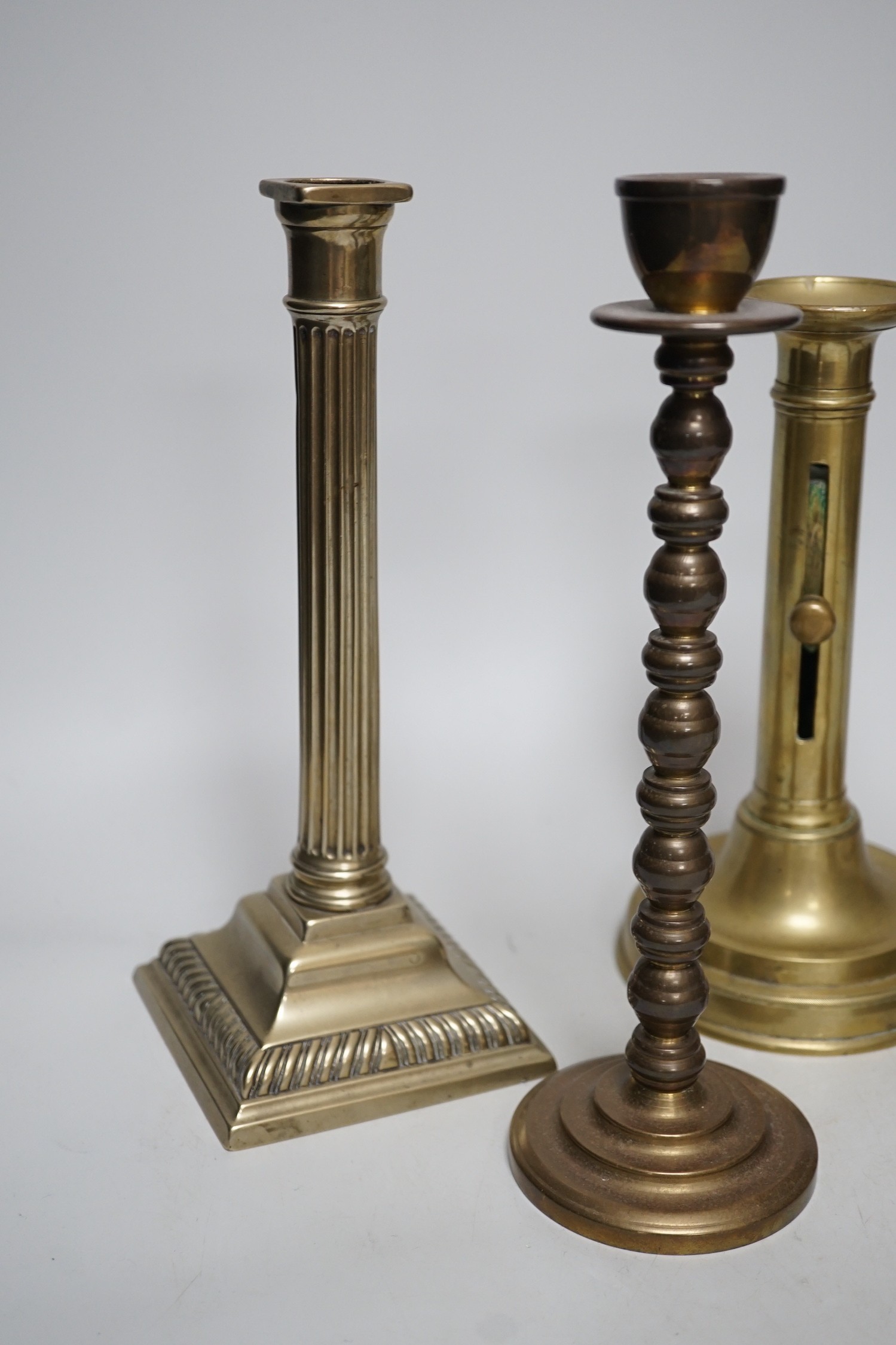 Five various brass candlesticks, tallest 26cms high